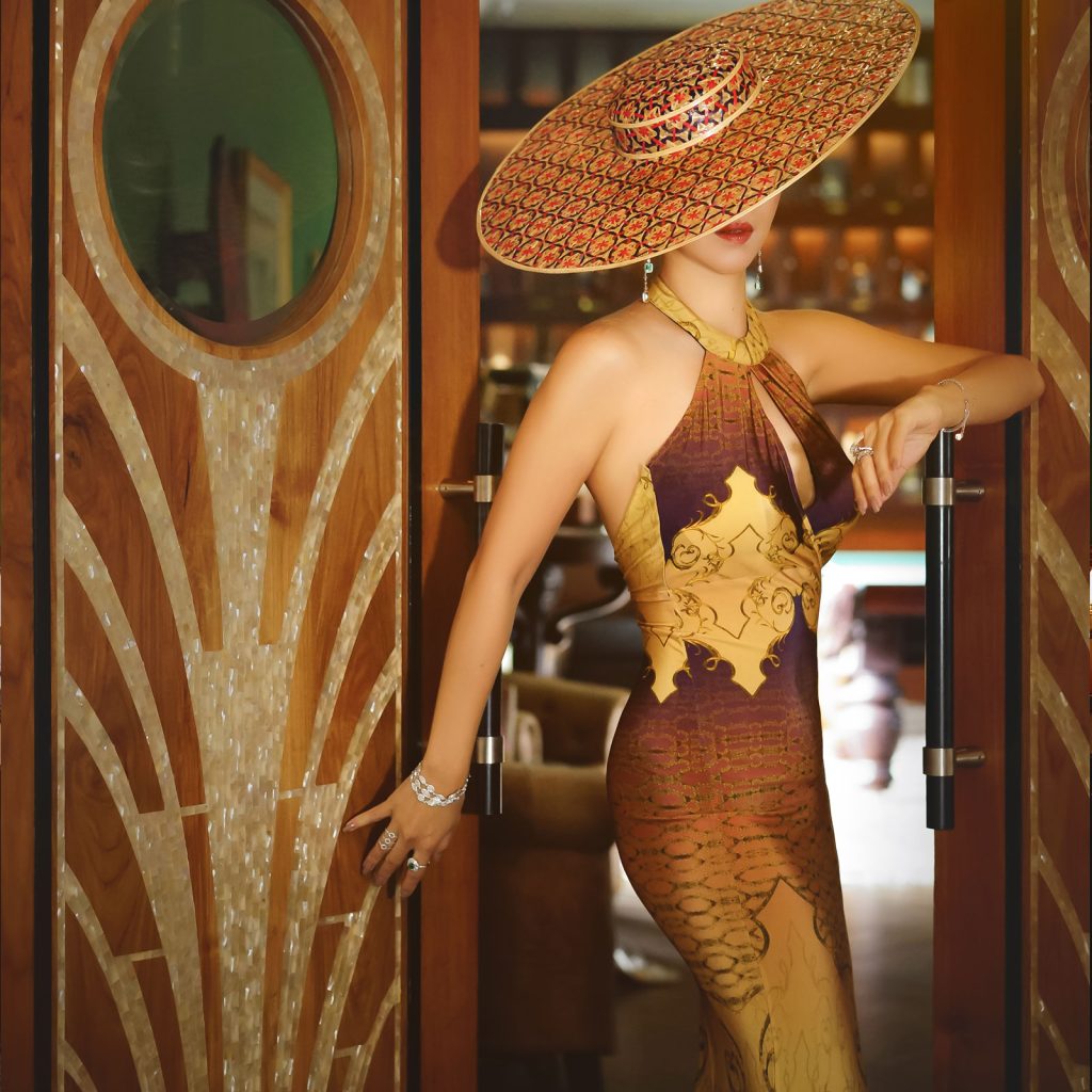 A woman standing next to a door in a photo shoot
