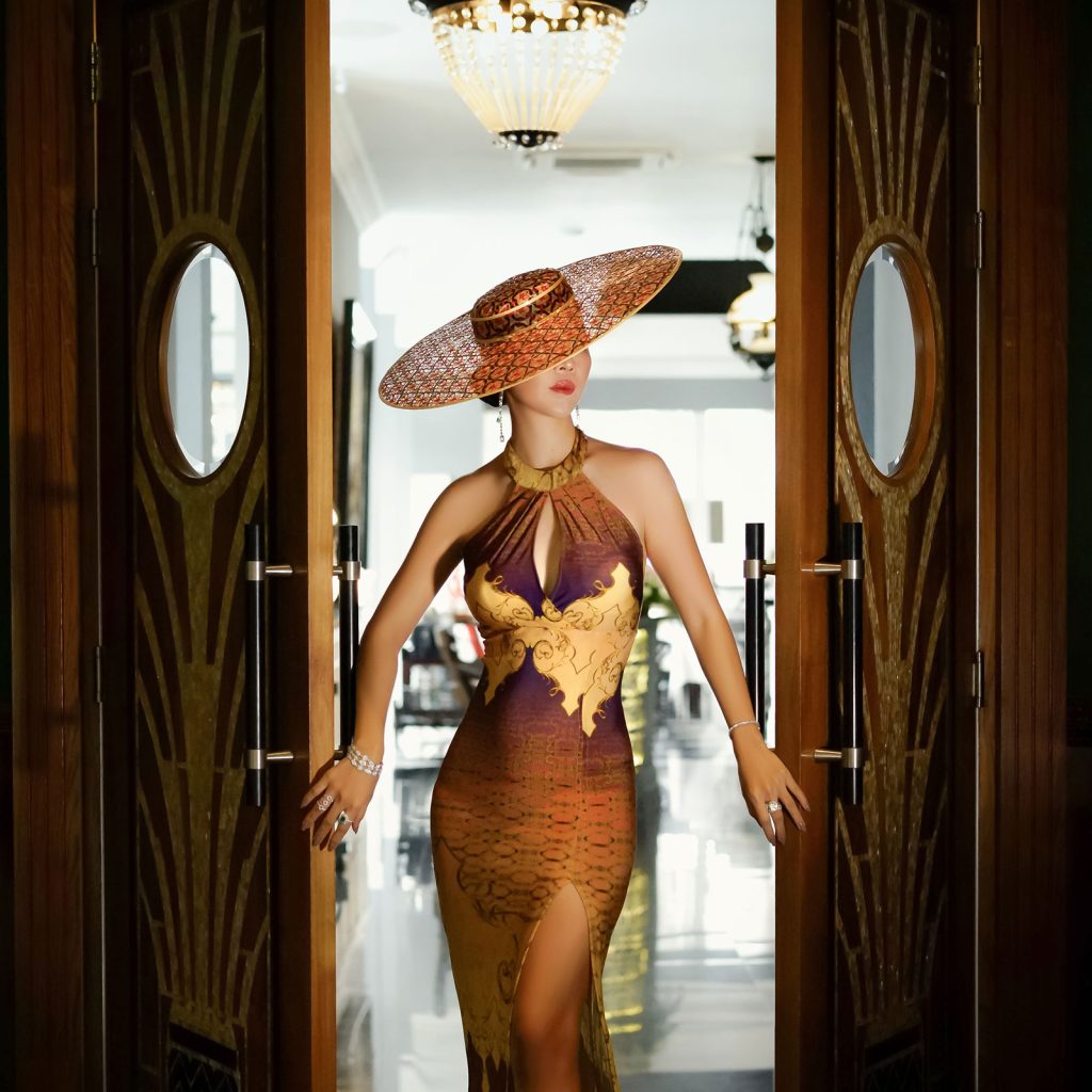 A woman posing near a door