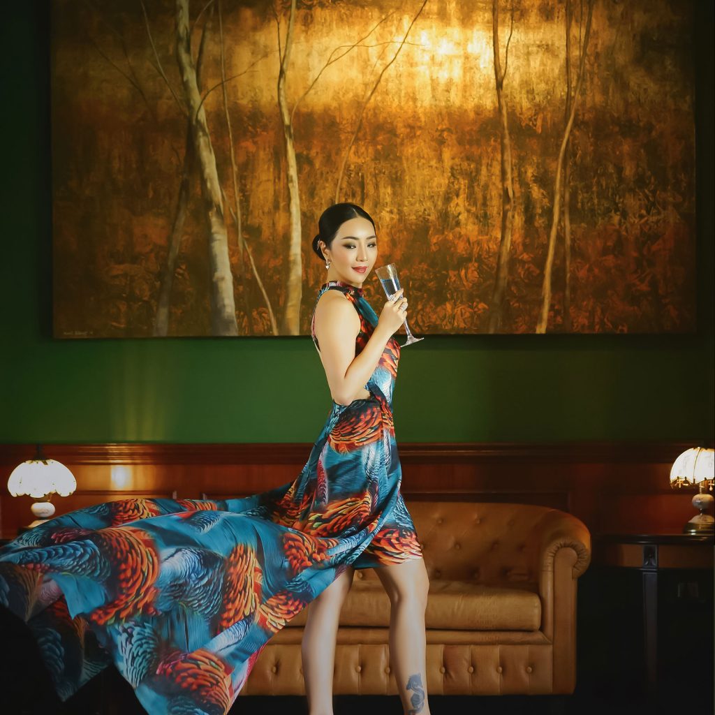 A woman posing with a beautiful dress