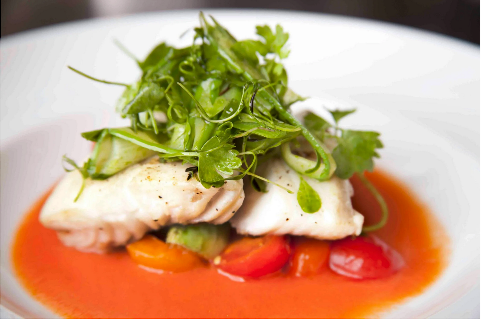 A fine dining meal of fish with greens