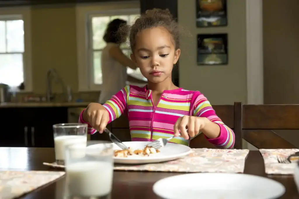 A kid eating a meal at a restaurant