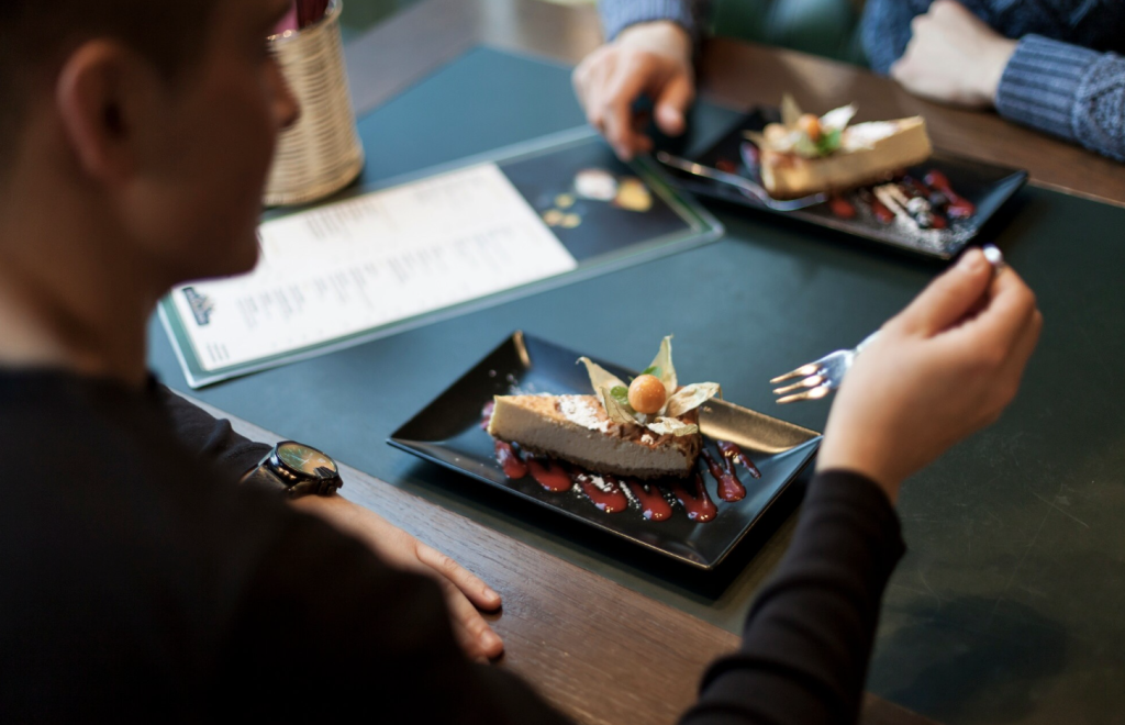 A customer about to eat a slice of gourmet cake