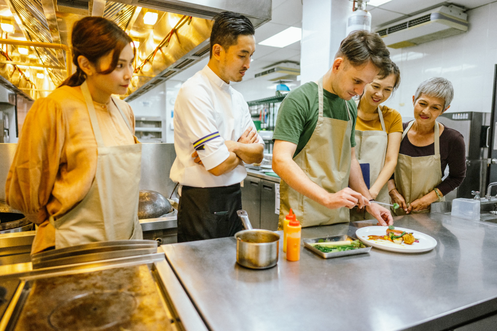 Culinary students learning from a fine-dining chef