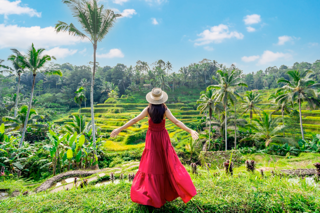 A woman in a red dress standing in a rice terrace in Ubud, Bali