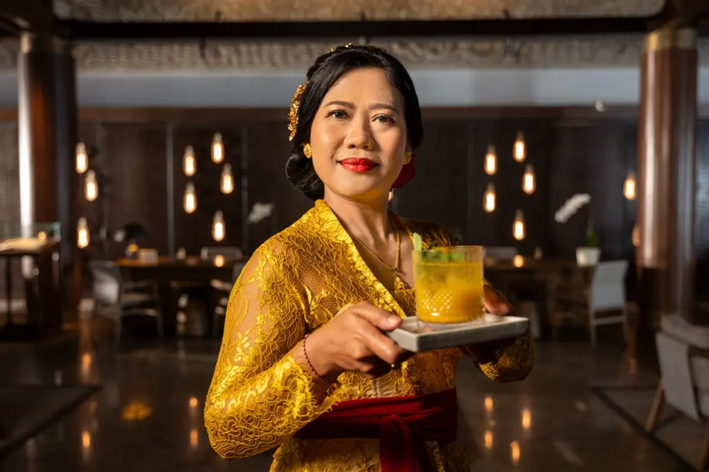 A local Balinese woman serving a cocktail