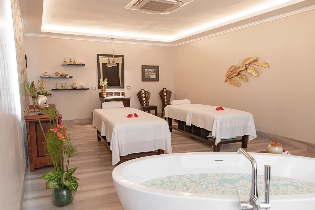 A spa in Ubud with massage tables and flower bath