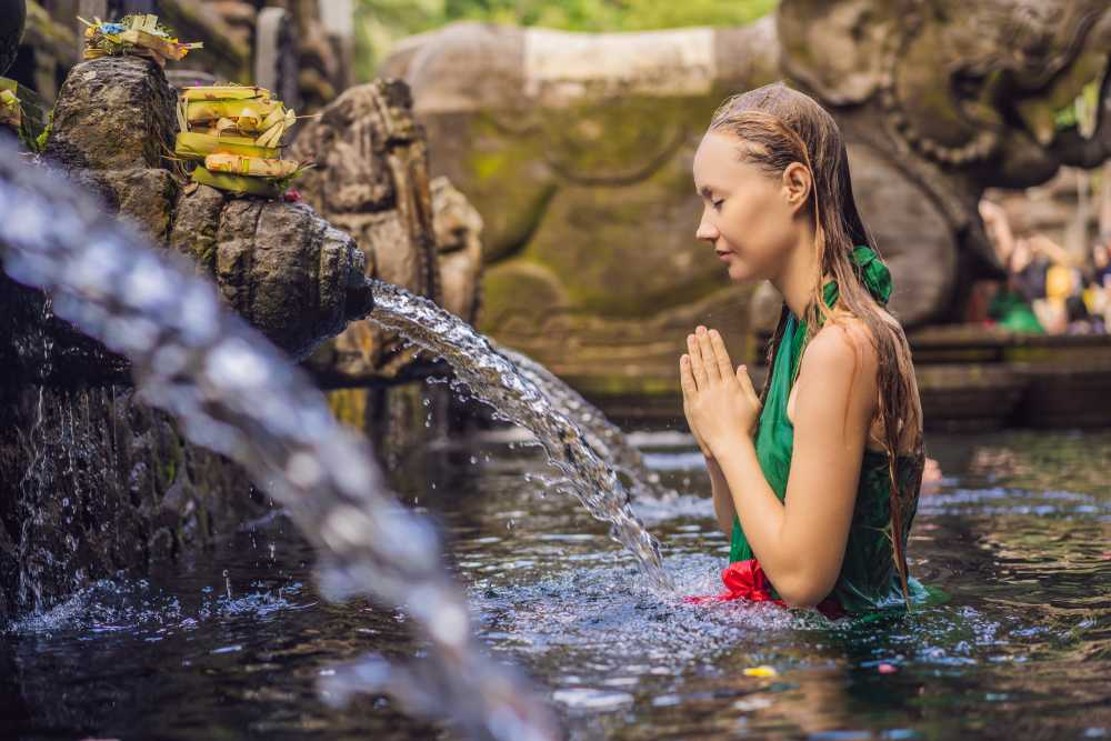 A woman doing a water purification in Ubud, Bali