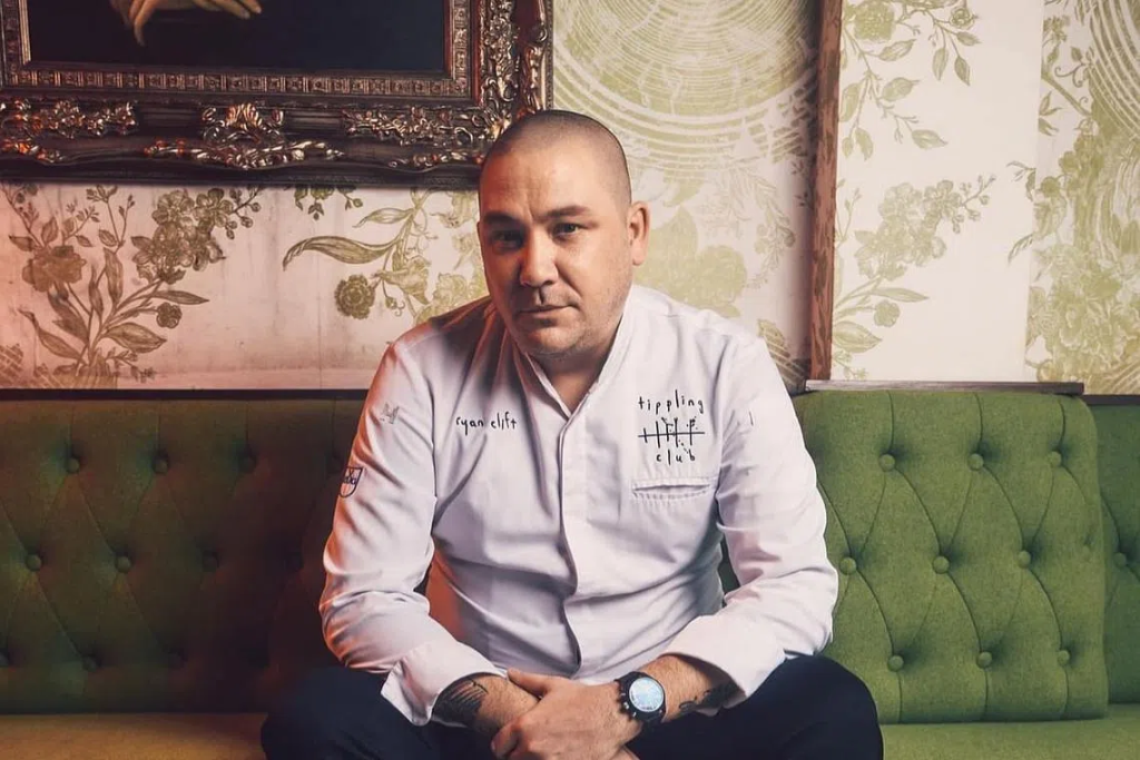 Chef Ryan Clift seated on a sofa