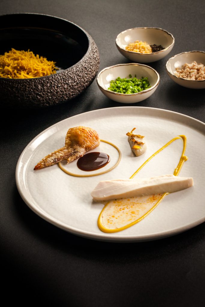 A fine dining Indonesian fusion meal of rice, chicken and condiments