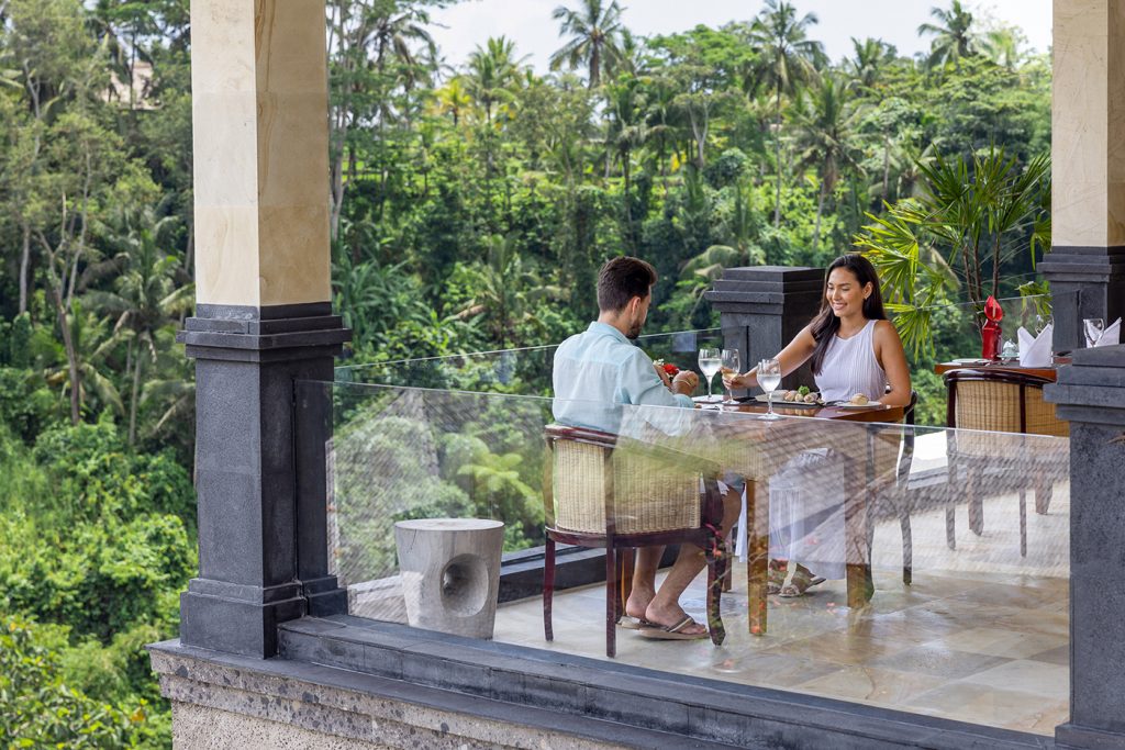 Two diners eating at a restaurant in Ubud with a jungle view