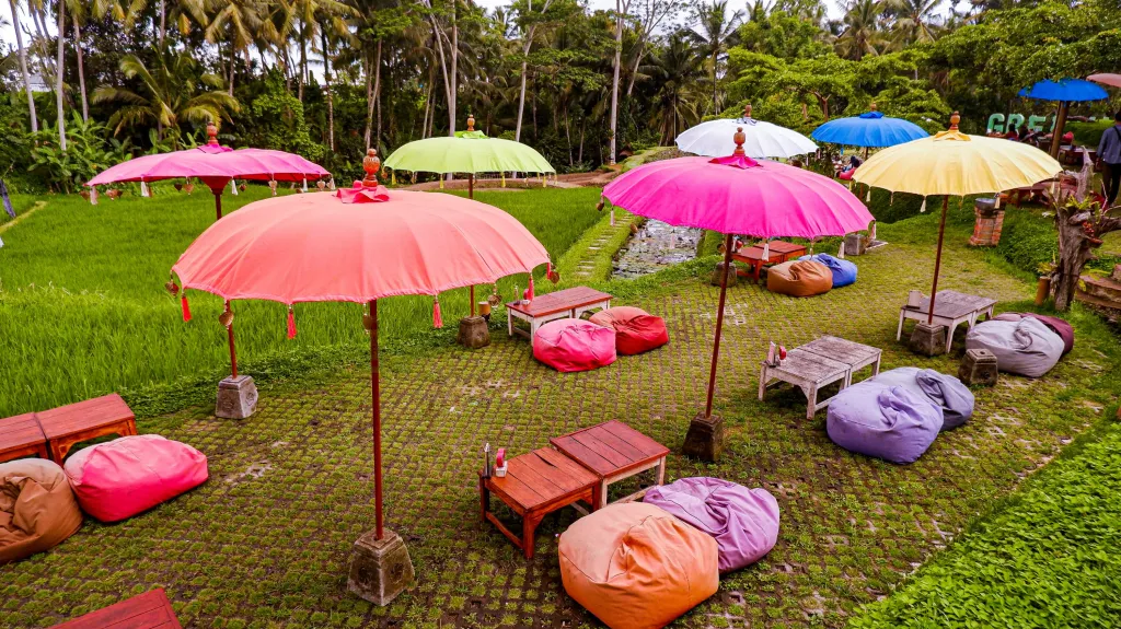 The rice paddy view from Green Kubu restaurant in Ubud with colourful bean bag seating and umbrellas