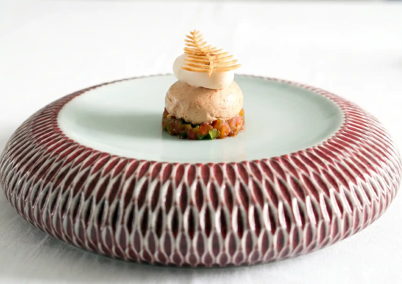 Fermented amuse-bouche with vegetable tartare and crispy garnish, fine dining Bali aperitif at an Ubud restaurant